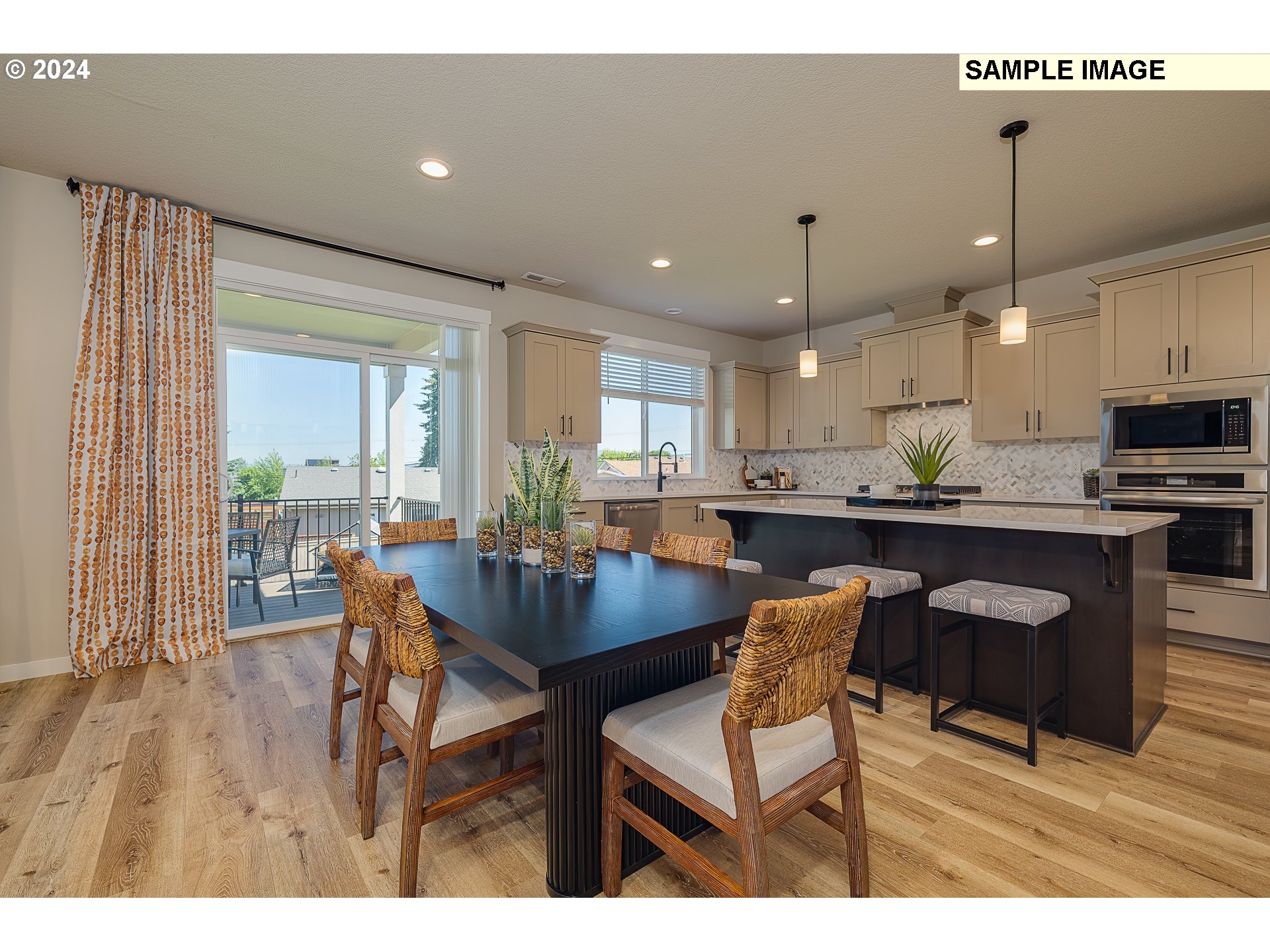 103 South 90th Place, Unit 131 Ridgefield, WA 98642 - Photo 14 of 32 a kitchen with stainless steel appliances kitchen island granite countertop a dining table chairs and white cabinets