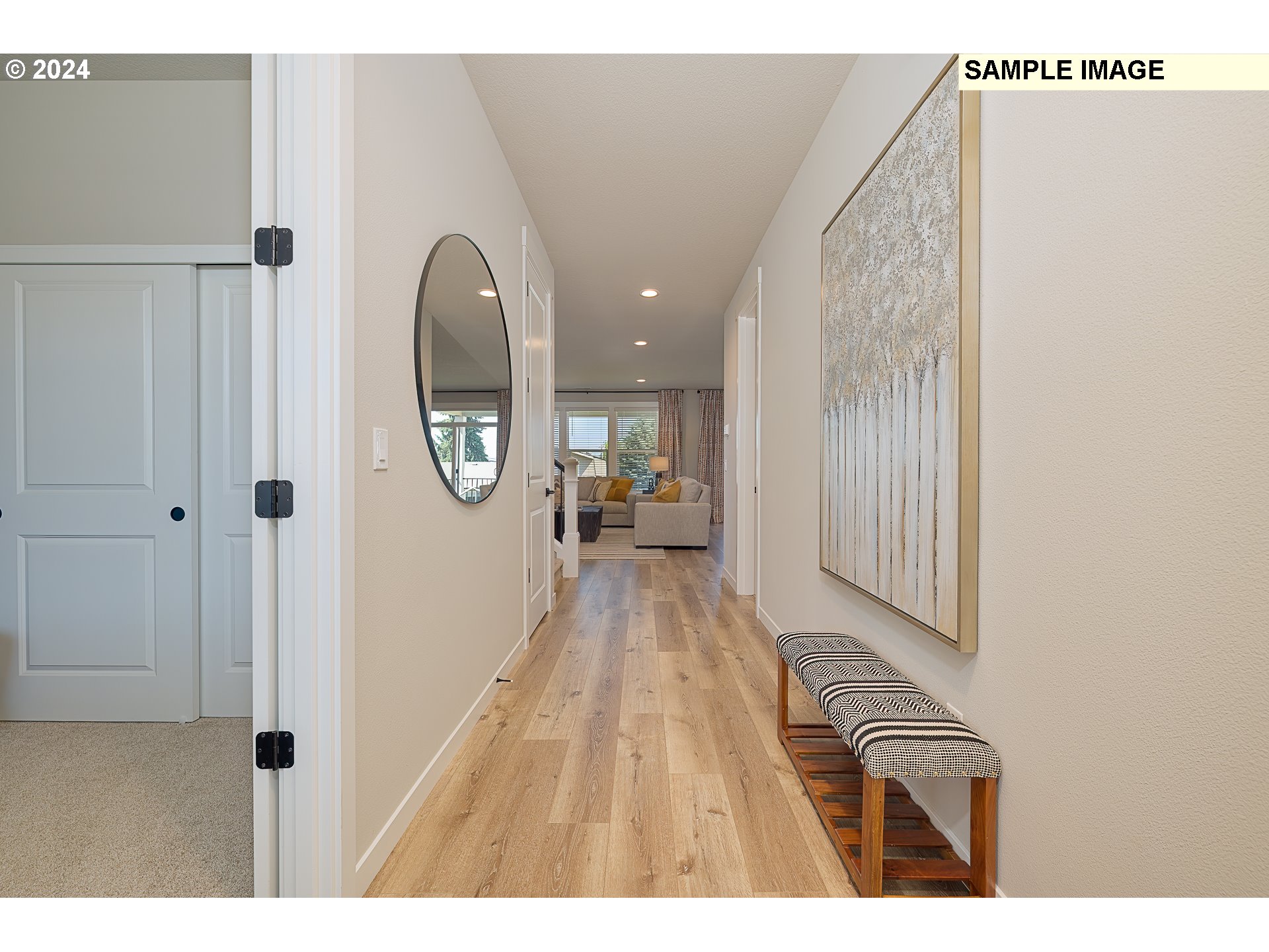 103 South 90th Place, Unit 131 Ridgefield, WA 98642 - Photo 4 of 32 a view of a hallway with wooden floor and a living room