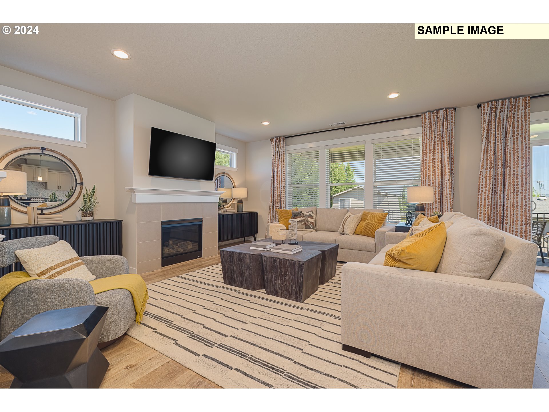 103 South 90th Place, Unit 131 Ridgefield, WA 98642 - Photo 6 of 32 a living room with furniture a fireplace and a flat screen tv