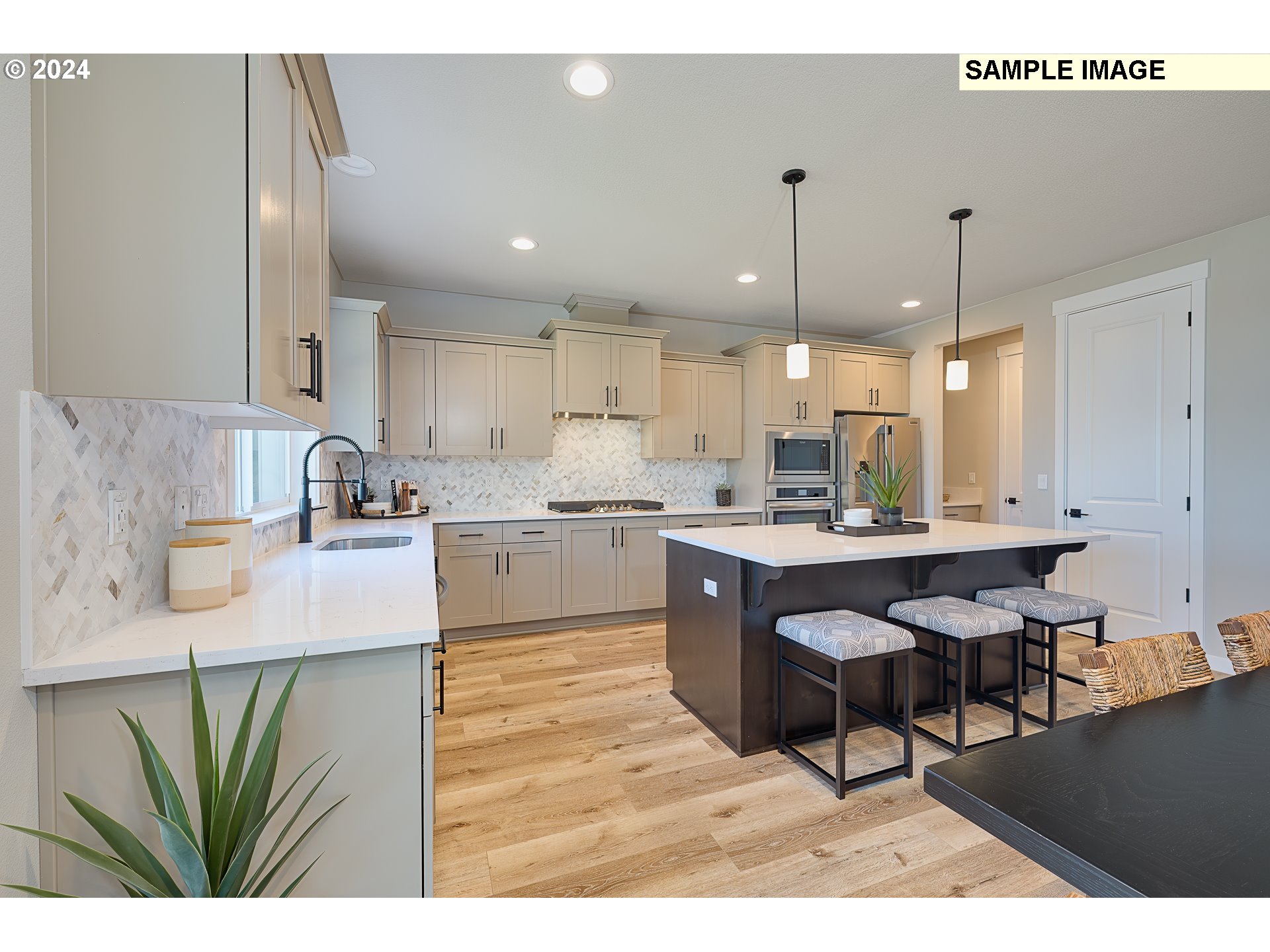 103 South 90th Place, Unit 131 Ridgefield, WA 98642 - Photo 8 of 32 a kitchen with kitchen island stainless steel appliances a sink and white cabinets