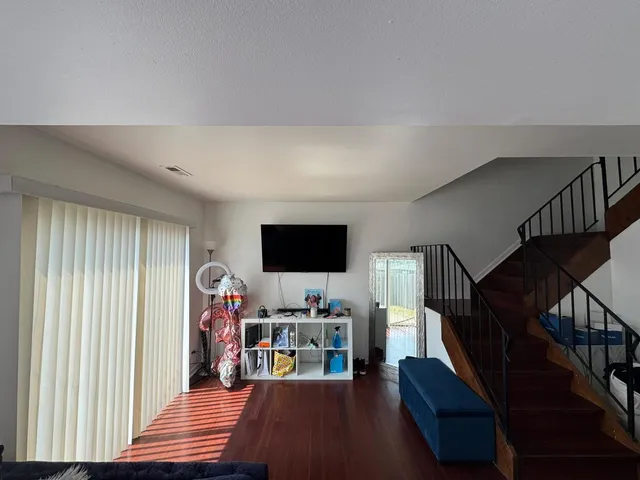 a living room with lots of furniture and a flat screen tv