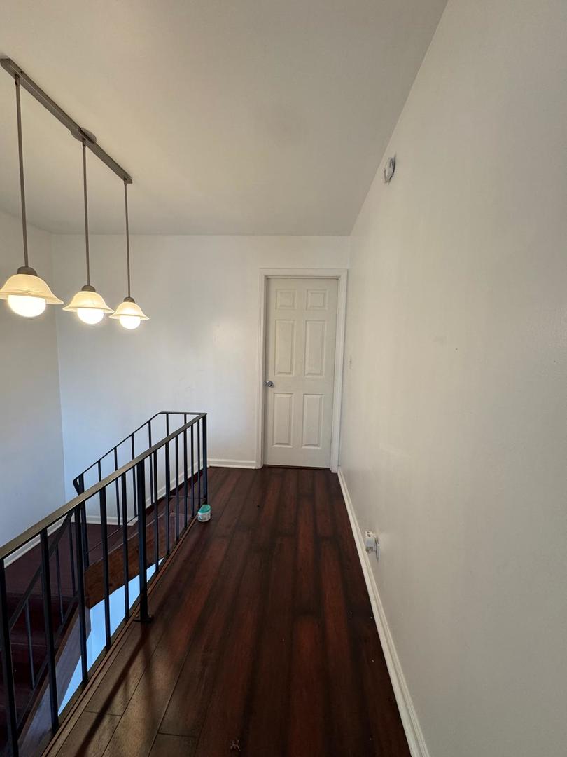 2605 East Martha Place Chicago, IL 60633 - Photo 6 of 10 a view of a hallway with wooden floor