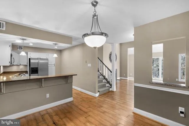 a view of a room with wooden floor and staircase