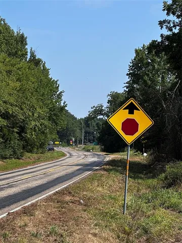 a view of green field with house in background