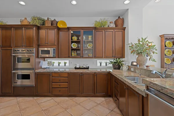 a kitchen with stainless steel appliances granite countertop a stove and a refrigerator