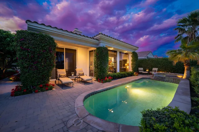 an aerial view of a house with swimming pool and patio