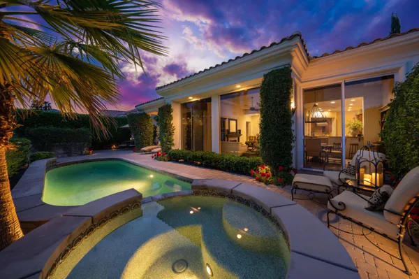 a view of a swimming pool and chairs in patio