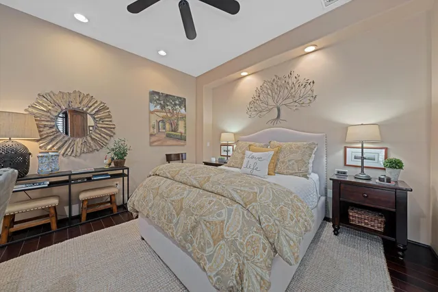 a bedroom with a bed and a flat tv screen on the dresser