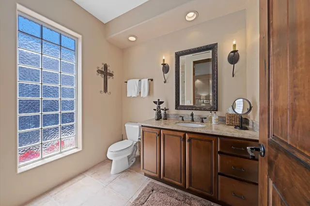 a bathroom with a granite countertop sink and a mirror