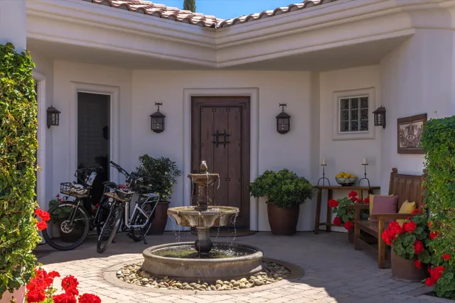 an outdoor sitting area with furniture and umbrella