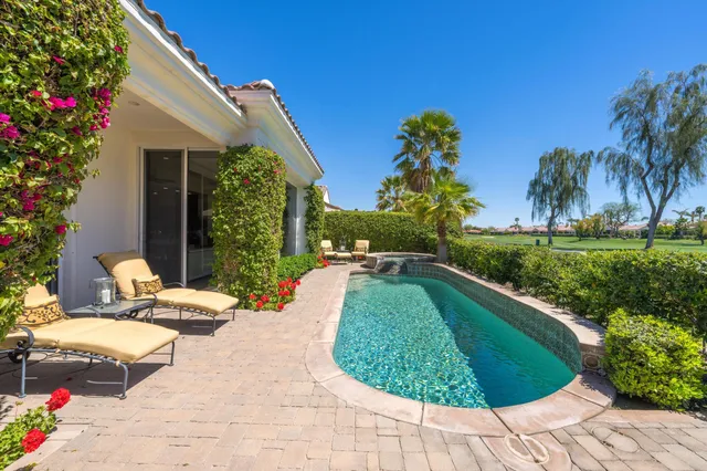 a view of a lush green hillside and houses