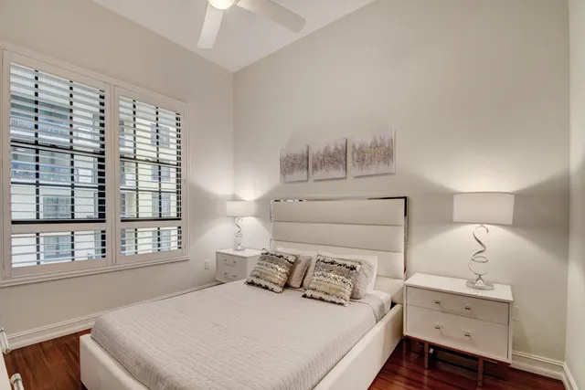 a bedroom with a bed and a large window