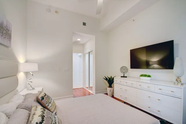 a bedroom with a flat screen tv and a bed