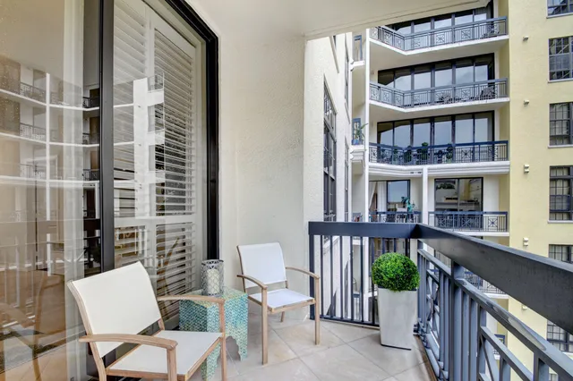 a balcony with table and chairs