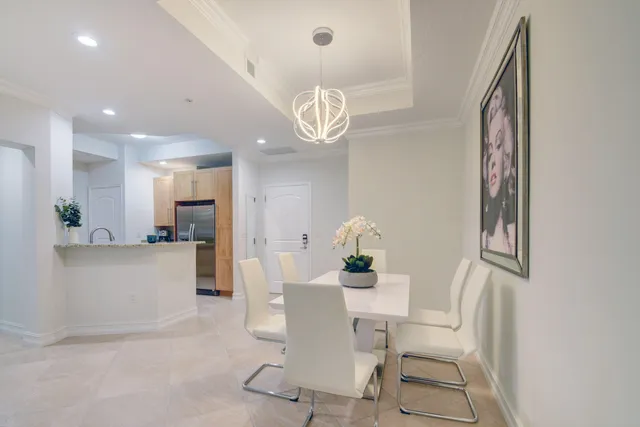 a view of a dining room with furniture and a chandelier