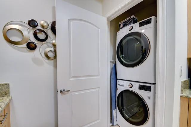 a view of a storage and utility room with washer and dryer