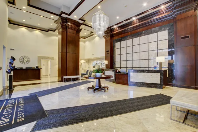 a front view of a house with entryway yard and potted plants