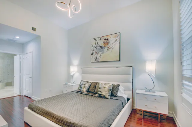 a bedroom with a bed and wooden floor