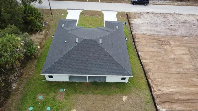 an aerial view of a house with swimming pool