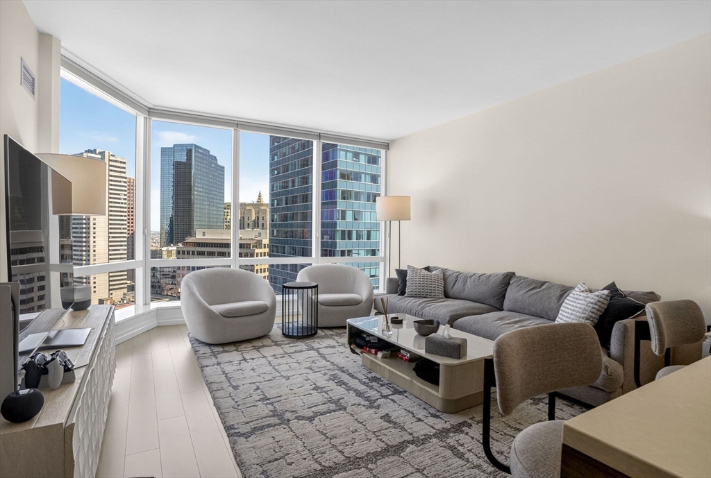1 Franklin Street, Unit 2805 Boston, MA 02110 - Photo 2 of 22 a living room with furniture and a large window