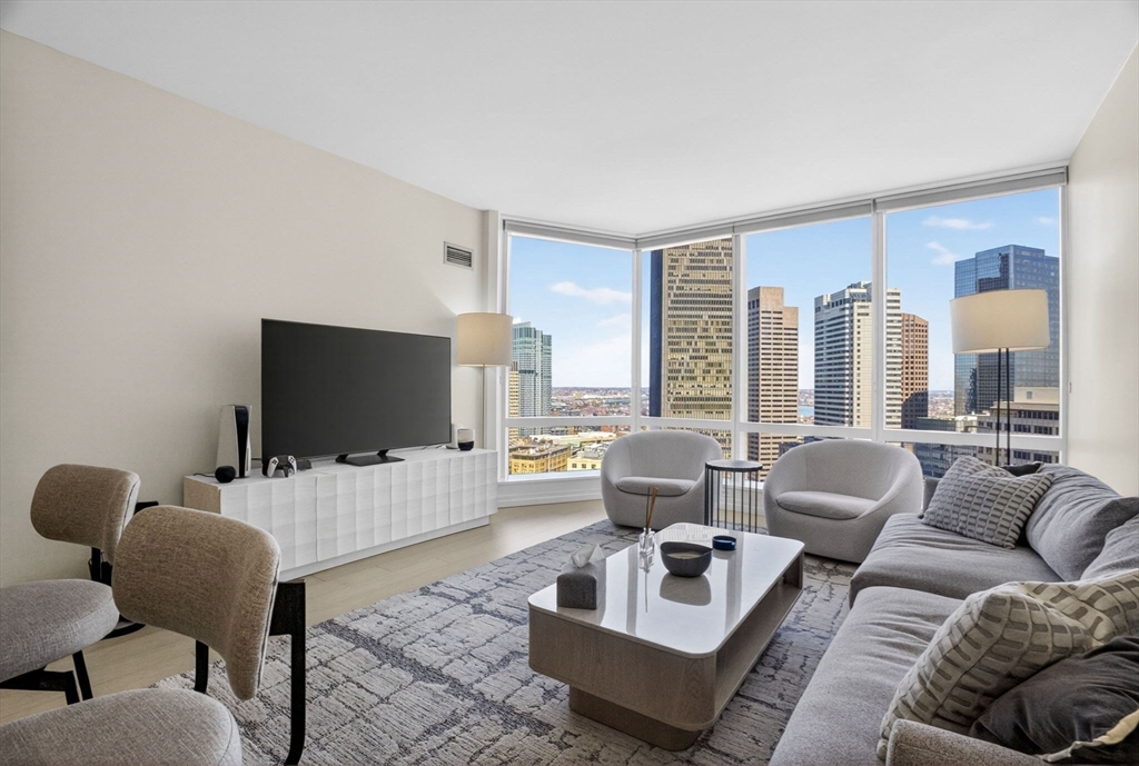 1 Franklin Street, Unit 2805 Boston, MA 02110 - Photo 3 of 22 a living room with furniture and a flat screen tv
