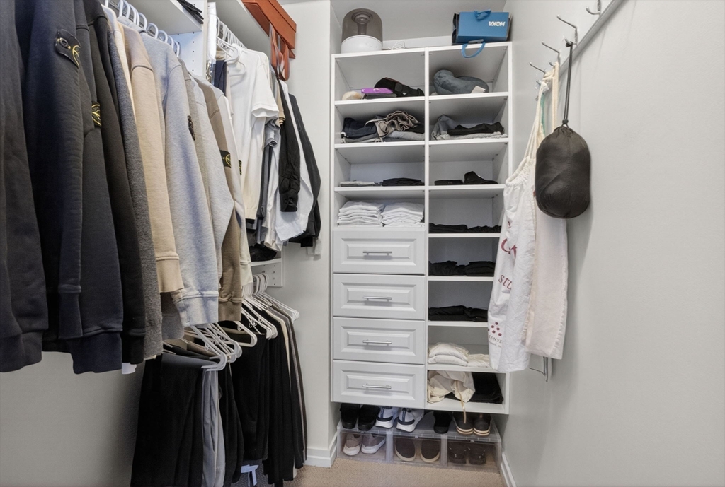 1 Franklin Street, Unit 2805 Boston, MA 02110 - Photo 9 of 22 a view of walk in closet with clothes and shoes