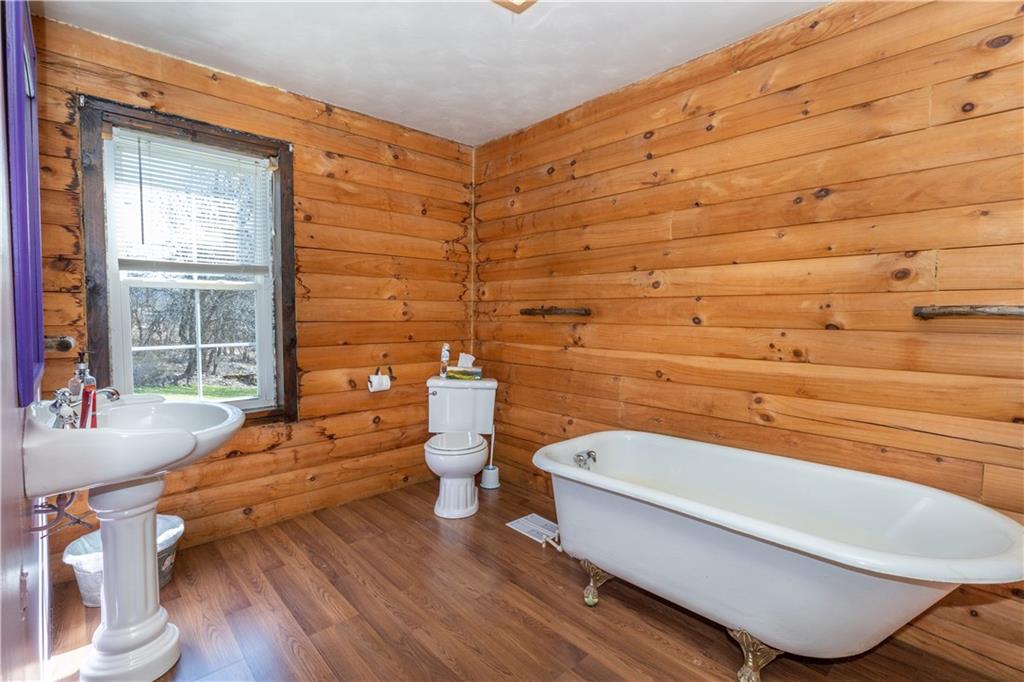 3348-3350 Springfield Pike Normalville, PA 15469 - Photo 9 of 25 a bathroom with a toilet a sink and bathtub