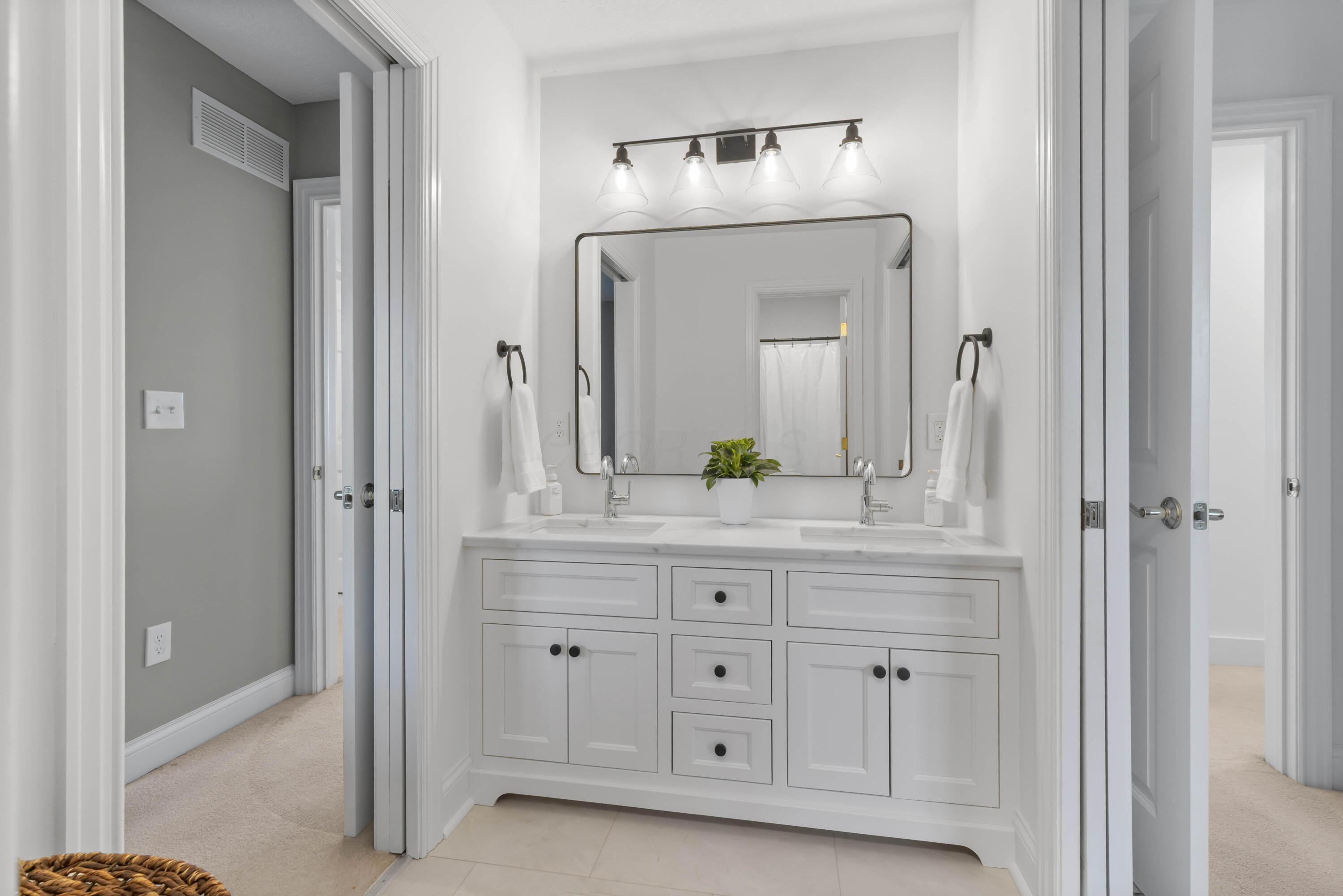 1364 Dale Ford Road Delaware, OH 43015 - Photo 62 of 112 • Luxury vinyl plank flooring • White painted walls • Custom built enclosed vanity with double bowl, quartz sinktop • 4 bulb wall light • Mirror remains