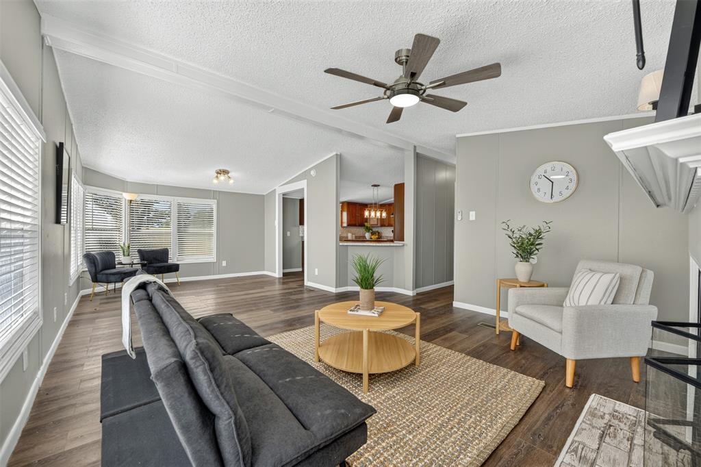 449 Big Salty Lane Springtown, TX 76082 - Photo 13 of 25 Spacious living area featuring wood-finish flooring, vaulted ceilings, and a modern ceiling fan
