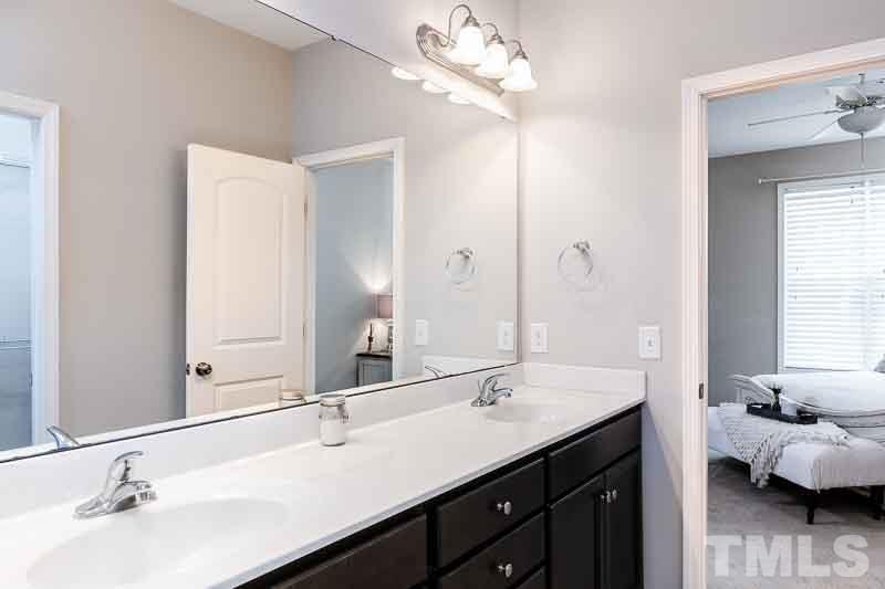 844 Horton Road, Unit 87 Durham, NC 27704 - Photo 12 of 21 a bathroom with a double vanity sink and a mirror
