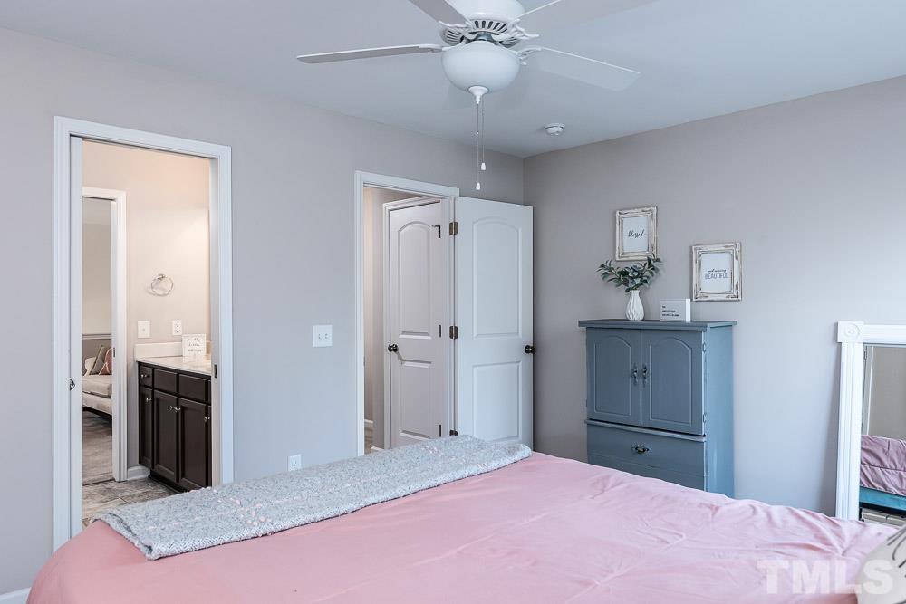 844 Horton Road, Unit 87 Durham, NC 27704 - Photo 16 of 21 a bedroom with a bed and a chandelier