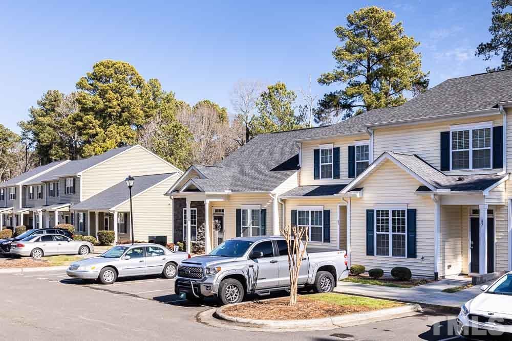 844 Horton Road, Unit 87 Durham, NC 27704 - Photo 21 of 21 a front view of a residential apartment building with a yard and parking spaces