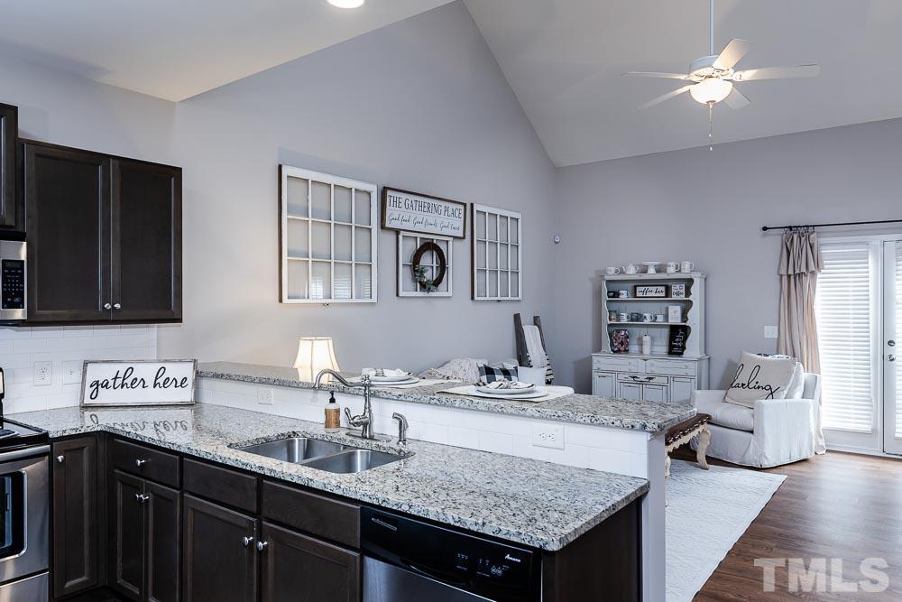 844 Horton Road, Unit 87 Durham, NC 27704 - Photo 8 of 21 a kitchen with a sink dishwasher and a stove with wooden floor