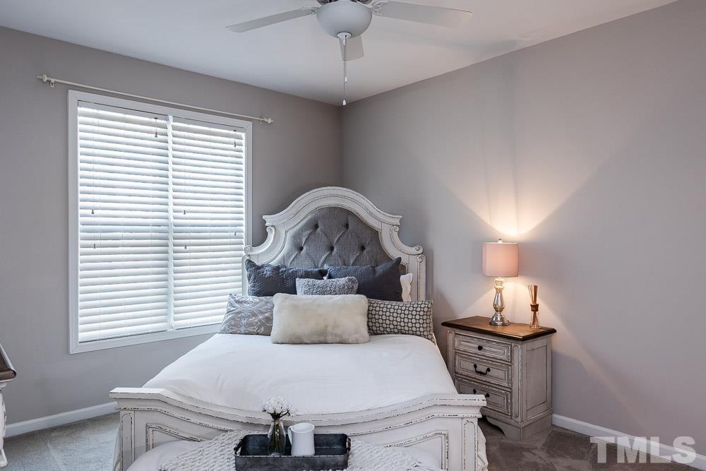 844 Horton Road, Unit 87 Durham, NC 27704 - Photo 10 of 21 a bedroom with a bed and a chandelier