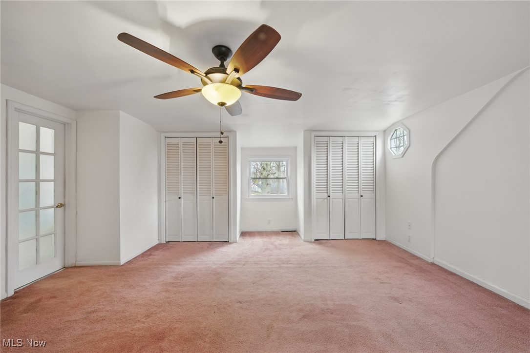 28575 White Road Wickliffe, OH 44092 - Photo 28 of 49 Unfurnished bedroom with light carpet, baseboards, multiple closets, and ceiling fan