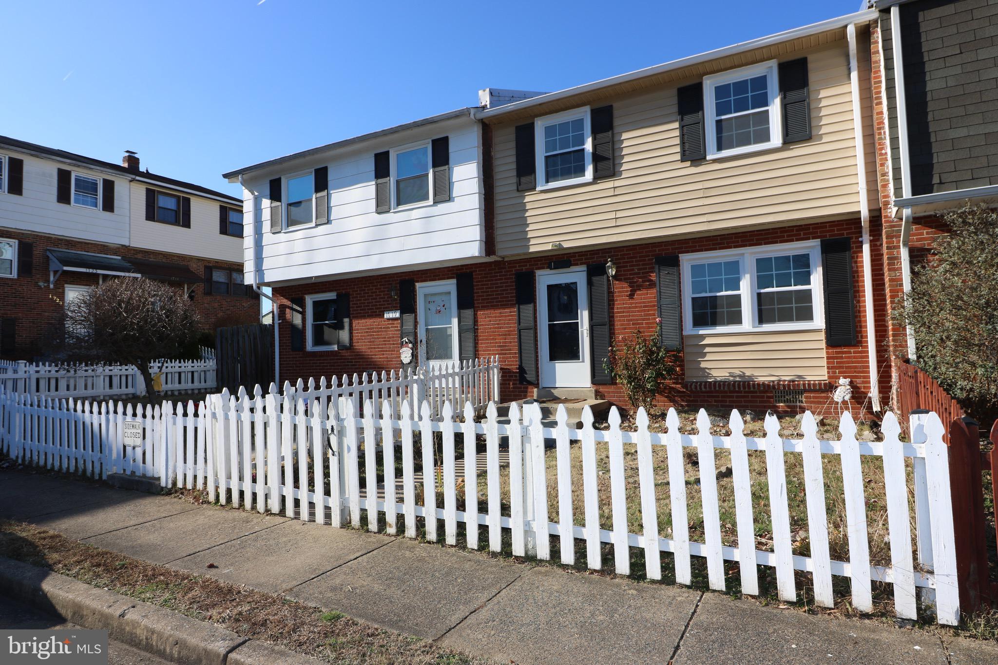 a front view of a house with a fence