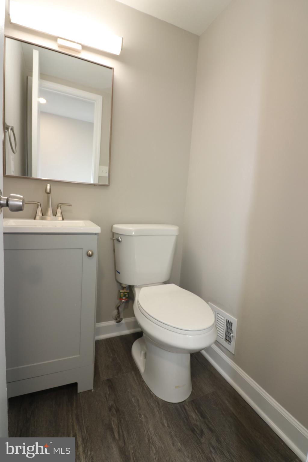 1717 Fort Henry Court Dumfries, VA 22026 - Photo 12 of 27 a bathroom with a toilet a sink and mirror