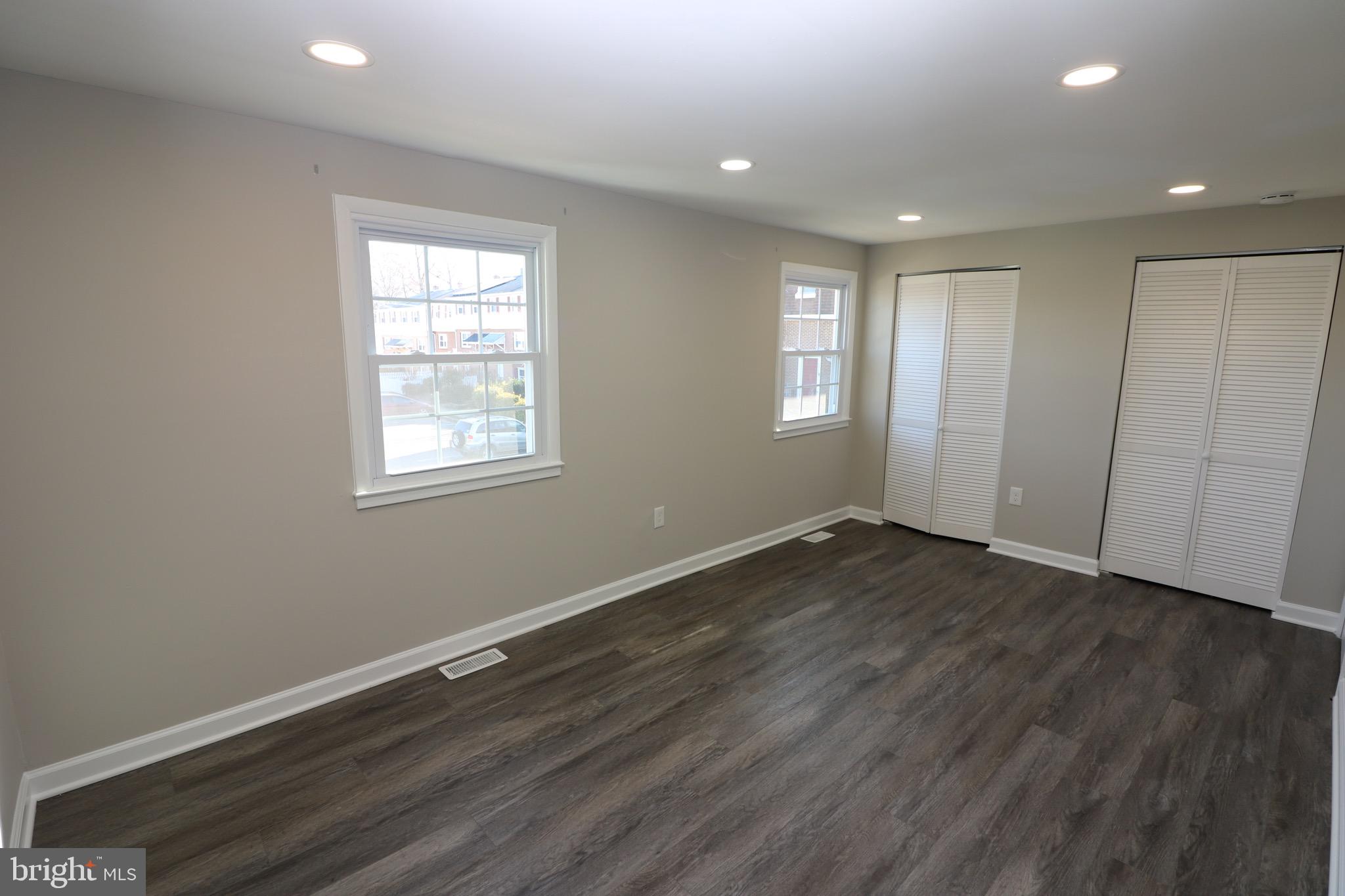 1717 Fort Henry Court Dumfries, VA 22026 - Photo 13 of 27 an empty room with wooden floor and windows
