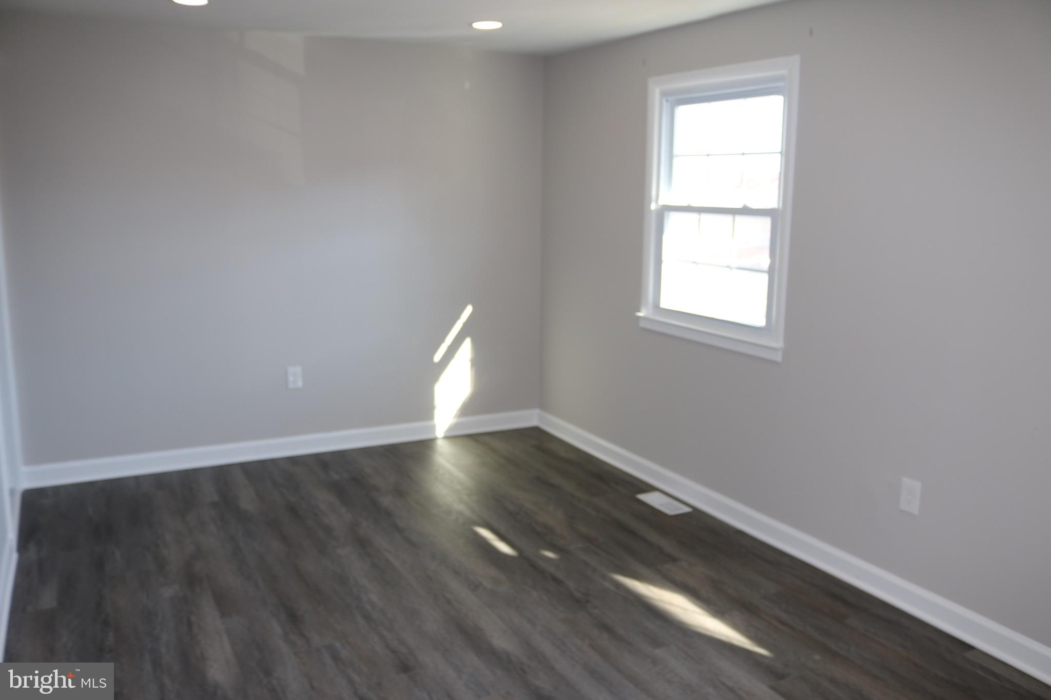1717 Fort Henry Court Dumfries, VA 22026 - Photo 14 of 27 an empty room with wooden floor and windows