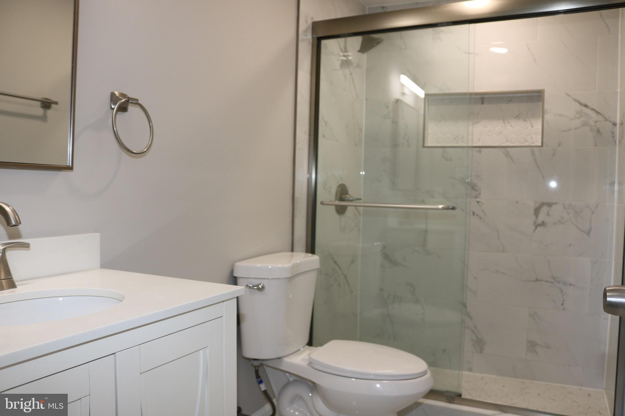1717 Fort Henry Court Dumfries, VA 22026 - Photo 16 of 27 a bathroom with a toilet sink vanity and shower