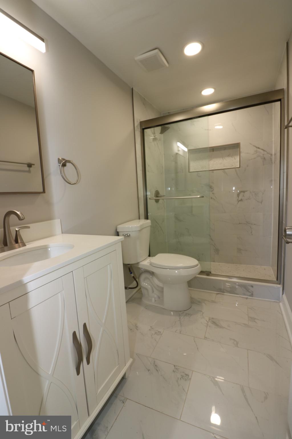 1717 Fort Henry Court Dumfries, VA 22026 - Photo 18 of 27 a bathroom with a toilet sink and a mirror