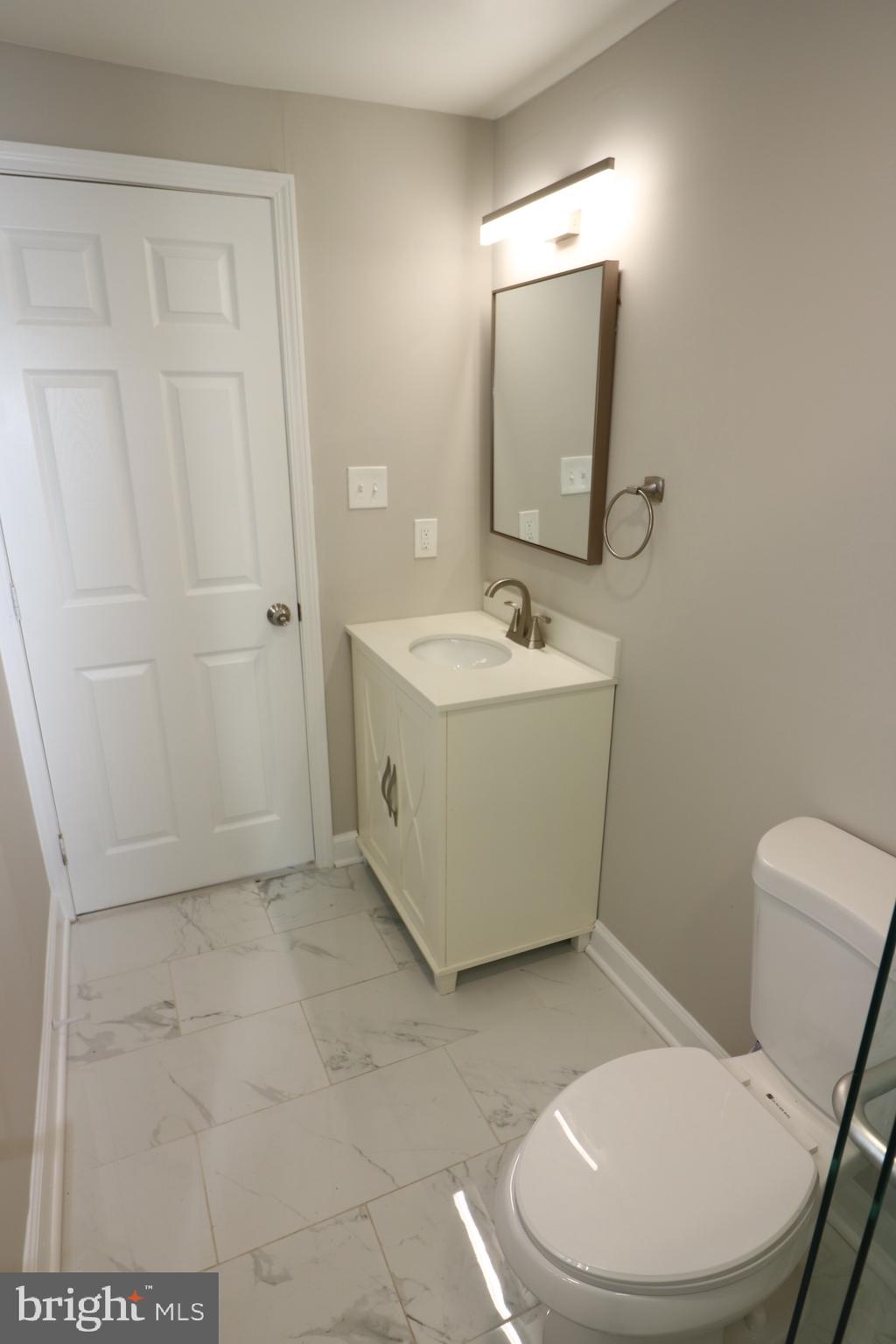 1717 Fort Henry Court Dumfries, VA 22026 - Photo 19 of 27 a bathroom with a sink toilet and mirror