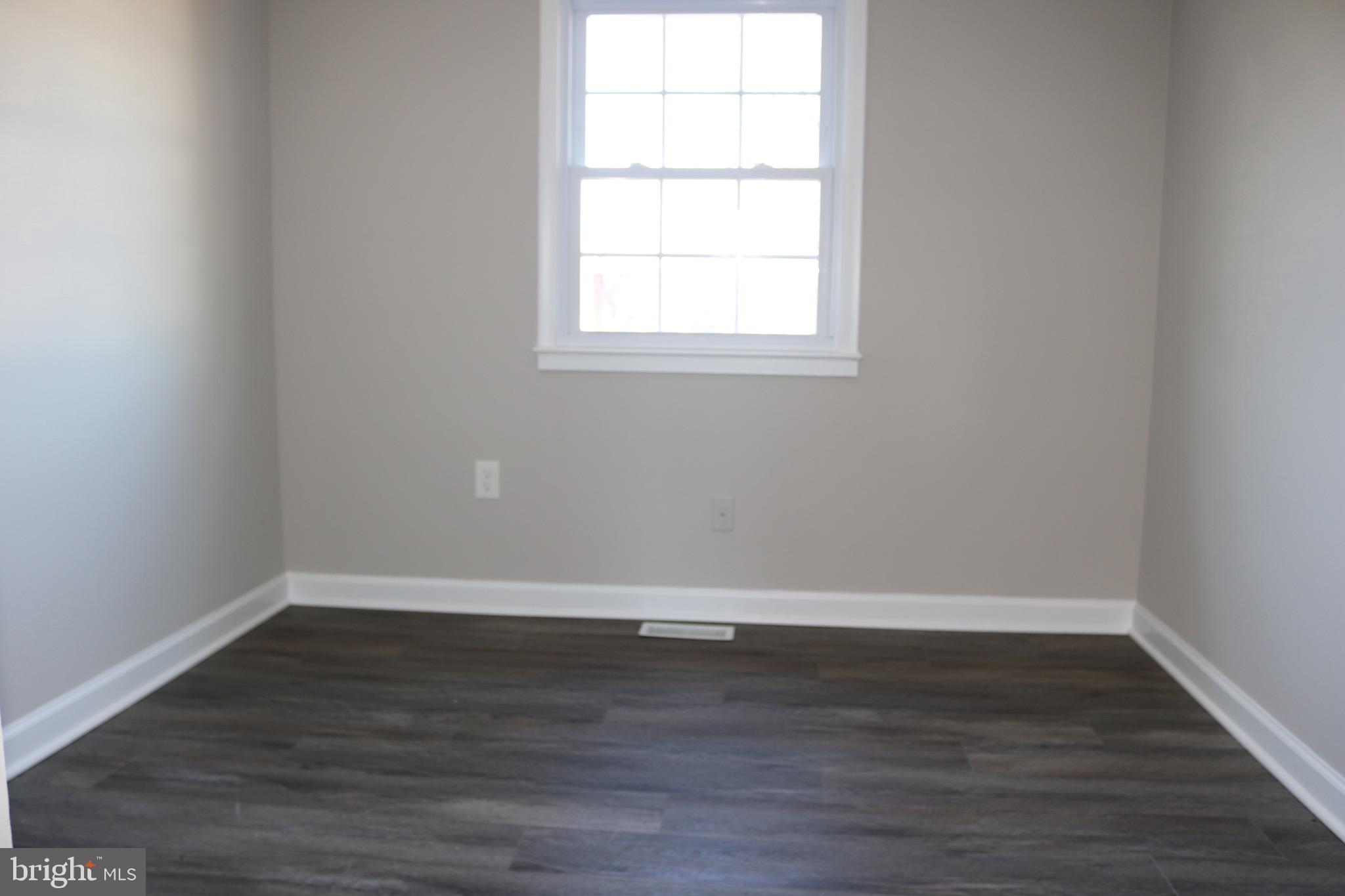 1717 Fort Henry Court Dumfries, VA 22026 - Photo 21 of 27 an empty room with wooden floor and windows