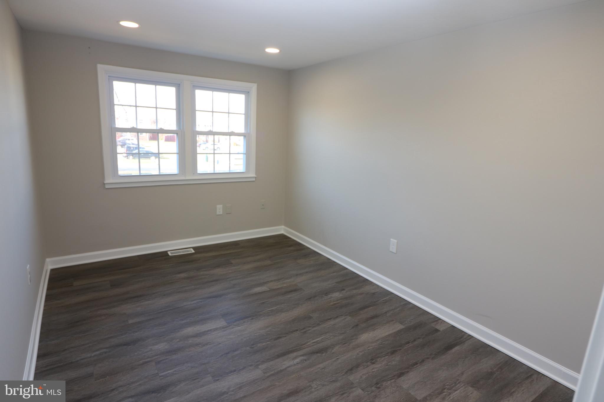 1717 Fort Henry Court Dumfries, VA 22026 - Photo 22 of 27 an empty room with wooden floor and windows