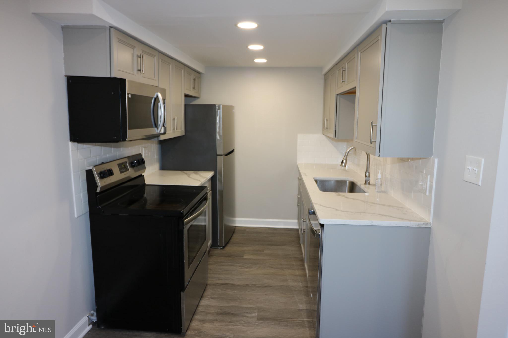 1717 Fort Henry Court Dumfries, VA 22026 - Photo 6 of 27 a kitchen with stainless steel appliances a refrigerator stove and microwave