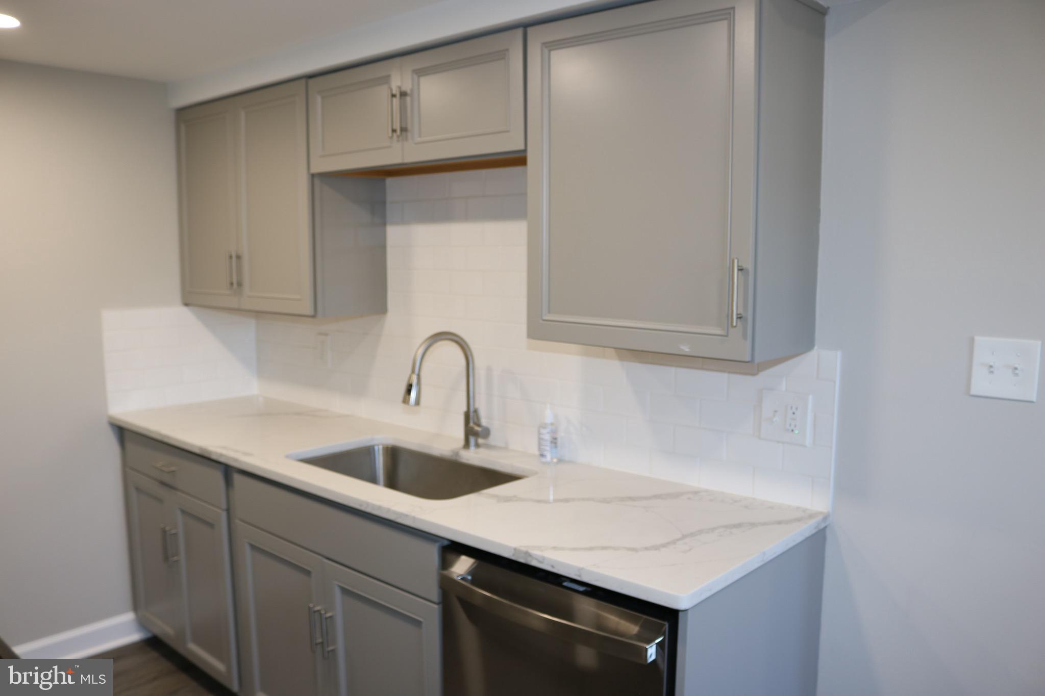 1717 Fort Henry Court Dumfries, VA 22026 - Photo 8 of 27 a kitchen with a sink cabinets and washing machine