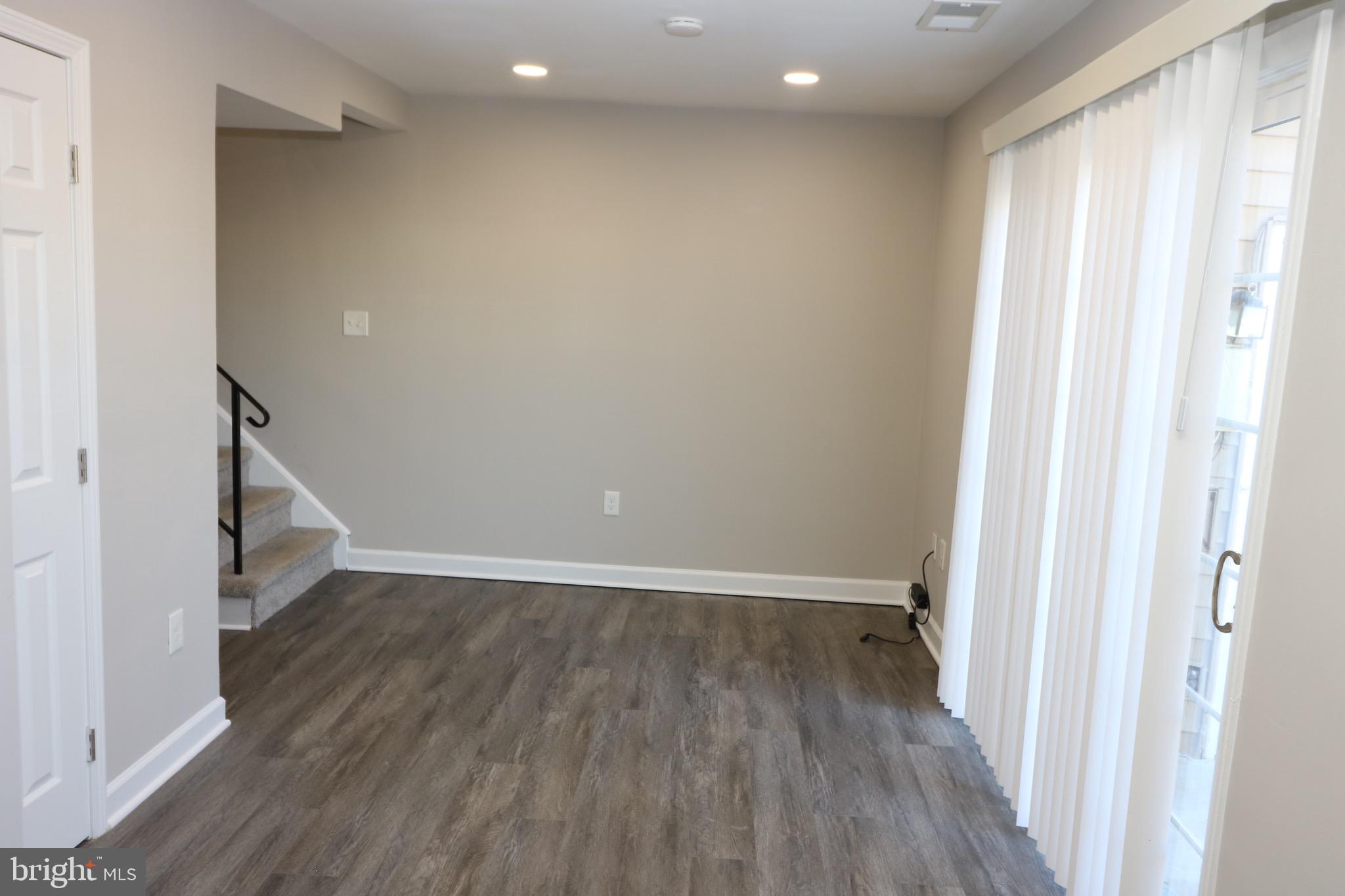 1717 Fort Henry Court Dumfries, VA 22026 - Photo 10 of 27 a view of an empty room with wooden floor and a window