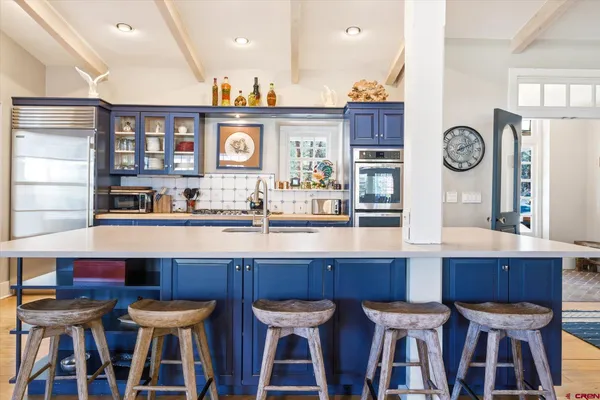 a dining table with chairs and cabinets