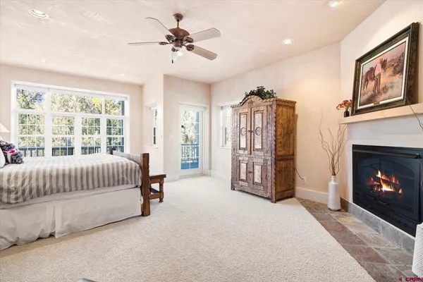 a living room with furniture a fireplace and a chandelier