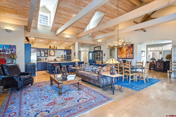 a living room with furniture kitchen view and a table